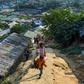 Rohingya refugees walk among makeshift houses in the Jamtoli Refugee Camp in Ukhia, Bangladesh in December 2019