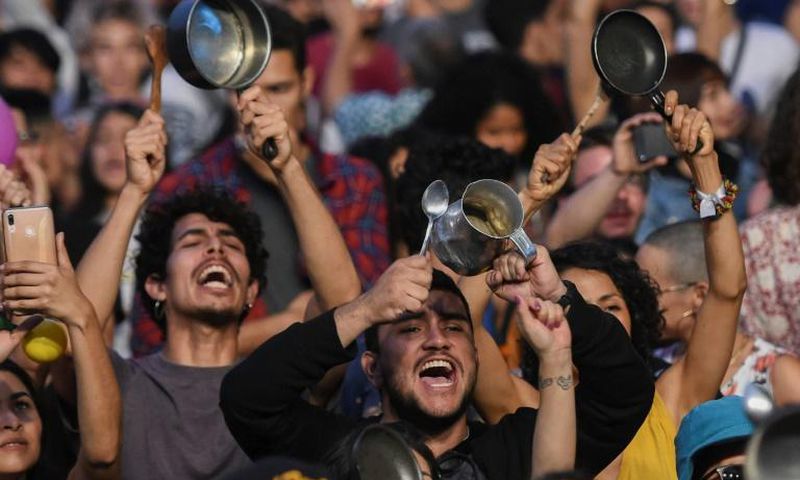 People bang pans and pots at a concert in support of the strike against President Ivan Duque's government in Medellin, Colombia on December 1, 2019