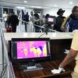 A thermal scanner screens passengers at Lagos international airport