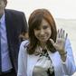Former Argentine president Cristina Kirchner -- who assumes the vice presidency next week -- waves as she arrives at a court in Buenos Aires