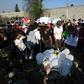People lay white balloons and flowers at the site where the body of a seven-year-old girl was found over the weekend with signs of torture in  Mexico City