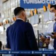 An airline staff member wears a mask while working at Arturo Merino Benitez International Airport in Santiago, Chile -- the new coronavirus has spread into Latin America and Africa