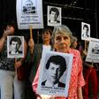 Beatriz Cantarini de Abriata holds a portrait of her son Hernan, who is believed to have been the victim of the "butcher" of Argentina's dictatorship Mario Sandoval, who has been arrested in France