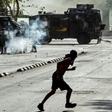 Demonstrators clash with riot police during a protest against President Sebastian Pinera's government in Santiago, on December 10
