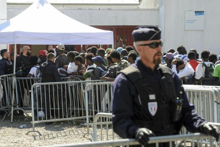 Macron says there has been a sharp increase in asylum claims since 2017