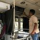 A driver and his assistant check and clean their sound system at the start of a journey in Biyagama, Sri Lanka. The government wants operators to turn down the volume on the notoriously loud vehicles