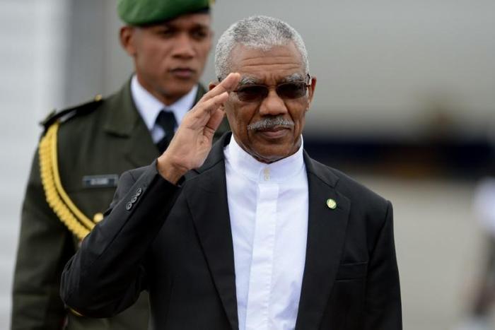 The ruling coalition of Guyana's President David Arthur, pictured in 2017, is in a tight race with theopposition People's Progressive Party