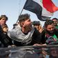 Angry Iraqi demonstrators mourn the killing of female activist and paramedic Janat Madhi, in Basra on Tuesday night, part of an upsurge of violence against the three-month-old protest movement