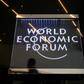 A man walks past a sign of the World Economic Forum (WEF) at the Congress Centre in Davos, eastern Switzerland