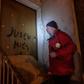 Aldo Rolfi, son of Italian writer Lidia Beccaria Rolfi (1925-1996), a former member of the Italian Resistance who was deported to Ravensbrueck concentration camp as a political prisoner, shows anti-Semitic tags written on his door to protesters