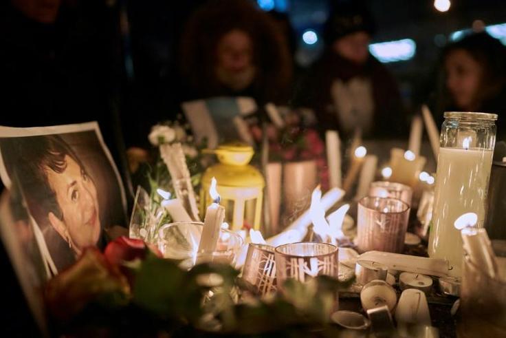 Candles light up a photo of one of the victims of an airliner crash in Iran that killed 176 people including 63 Canadians