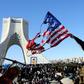 An Iranian woman marks the 41st anniversary of the Islamic republic by burning the US flag in Tehran's Azadi Square