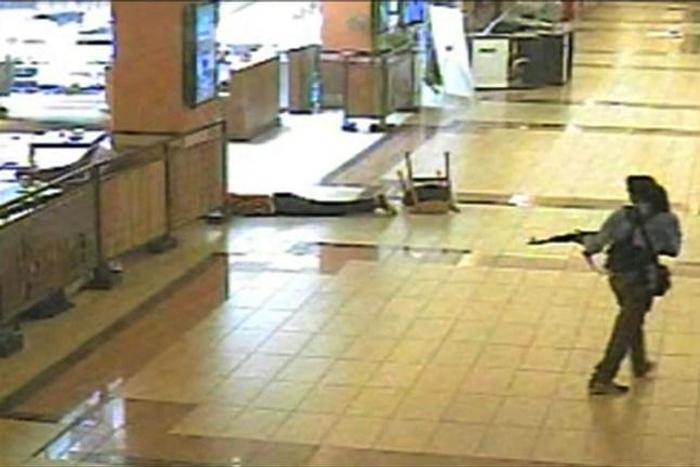An armed man walks during an attack on the Westgate mall in Nairobi in September 2013