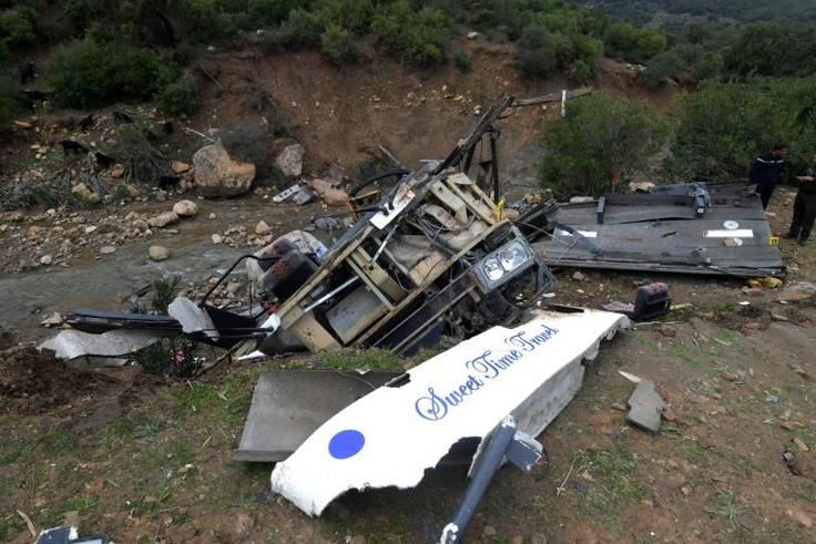 Tunisian security forces check the debris of a bus that plunged over a cliff into a ravine in northern Tunisia
