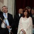 Argentina's new president, Alberto Fernandez, waves next to his vice-president Cristina Fernandez de Kirchner, after receiving the presidential sash from outgoing leader Mauricio Macri