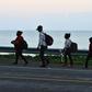 Honduran migrants in the northern coastal town of Omoa make their way to San Pedro Sula to join a caravan heading to the southern US border