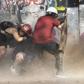 Demonstrators take cover as they clash with riot police during a protest against Chilean President Sebastian Pinera's government in Santiago, on January 17, 2020