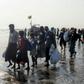 The 17 men, women and children looking exhausted from their ordeal as they climbed down from a wooden boat on to a beach near western Rakhine state's capital, Sittwe