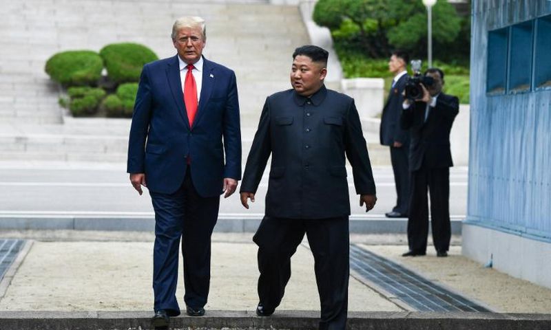 North Korea's leader Kim Jong Un and US President Donald Trump cross south of the Military Demarcation Line that divides North and South Korea, after Trump briefly stepped over to the northern side in June 30, 2019