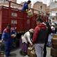 A man downloads gas cylinders from a truck in La Paz as life gets back to normal after weeks of protests