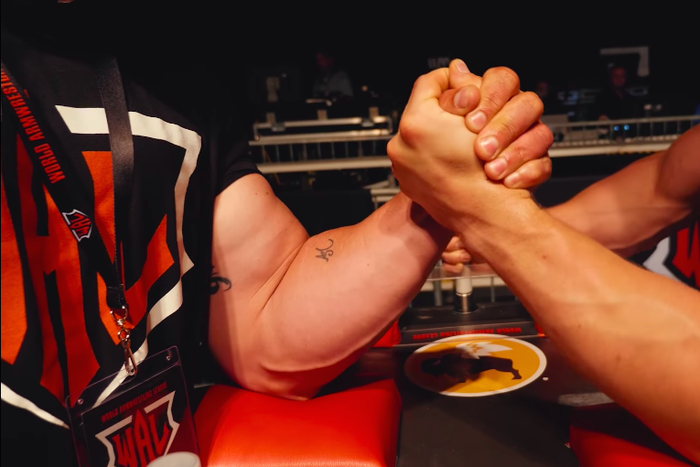 Watch Arm Wrestling Pros Crush This Bodybuilder