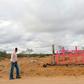 A woman walks near pink crosses placed in memory of eight murdered women at Lomas de Poleo, in Ciudad Juarez -- once dubbed the "murder capital of the world"