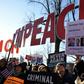 People rally in support of the impeachment of US President Donald Trump in front of the US Capitol, as the House of Representatives prepares for a landmark vote