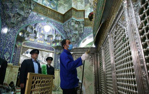 Iranian sanitary workers disinfect the Masumeh shrine in the Shiite holy city of Qom, where a prominent local member of parliament is among the latest people infected with the coronavirus