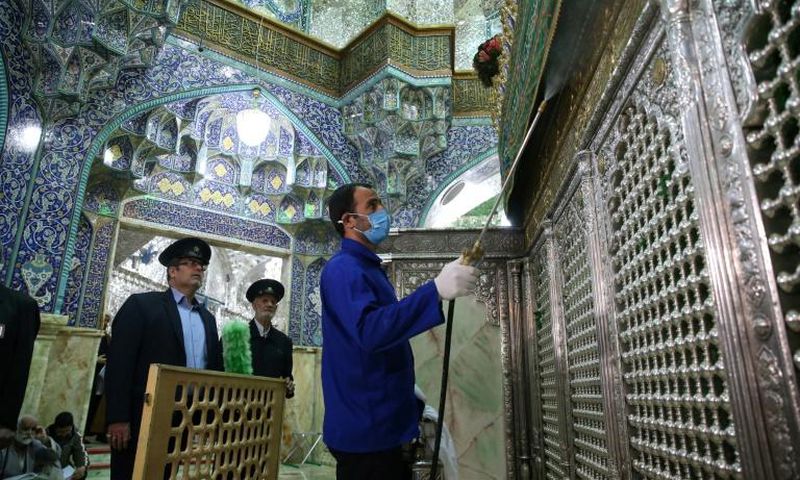 Iranian sanitary workers disinfect the Masumeh shrine in the Shiite holy city of Qom, where a prominent local member of parliament is among the latest people infected with the coronavirus