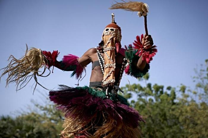 Defiance: A masked man wearing a traditional Dogon costume dances at the opening of the Segou'Art Festival, which takes place despite the threat of jihadist attacks