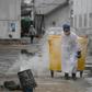 A worker moves medical waste at a hospital in Beijing treating coronavirus patients