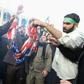 Iranians burn a US flag during a demonstration against American "crimes" in Tehran  following the killing of Iranian Revolutionary Guards Major General Qasem Soleimani in a US strike on his convoy at Baghdad international airport