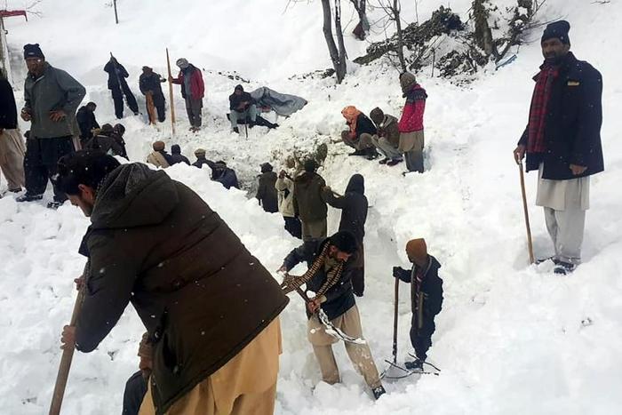 Local residents search for victims of an avalanche that hit the  Neelum Valley in Pakistan-administered Kashmir