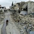 A man rides a motorbike through the almost-deserted town of Kafranbel on February 15, just days before its capture by the regime