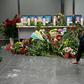 Dozens of people -- airline staff, passengers and locals alike -- gathered in the departure area to pay their respects to the crew, five men and four women