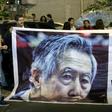 Supporters of Peruvian ex-president Alberto Fujimori (pictured October 2018) hold up posters of the former leader, who has been hospitalized for neurological and pulmonary issues