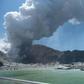 This handout photograph courtesy of Michael Schade shows the volcano on New Zealand's White Island spewing steam and ash minutes following a deadly eruption