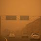 Cars drive on the TF-1 highway during a sandstorm in Santa Cruz de Tenerife, Spain, on February 23, 2020; airports on Spain's Canary Islands were closed after strong winds carrying red sand from the Sahara shrouded the tourist hotspot