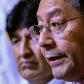 Former Bolivia president Evo Morales (in the background) and presidential candidate Luis Arce face a race against time to register for May's general election