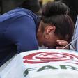 A relative mourns over the coffin of former FARC guerrilla Manuel Antonio Gonzalez on December 17, 2019, in Medellin, near the end of the deadliest year for the former Colombian rebels since a 2016 peace deal