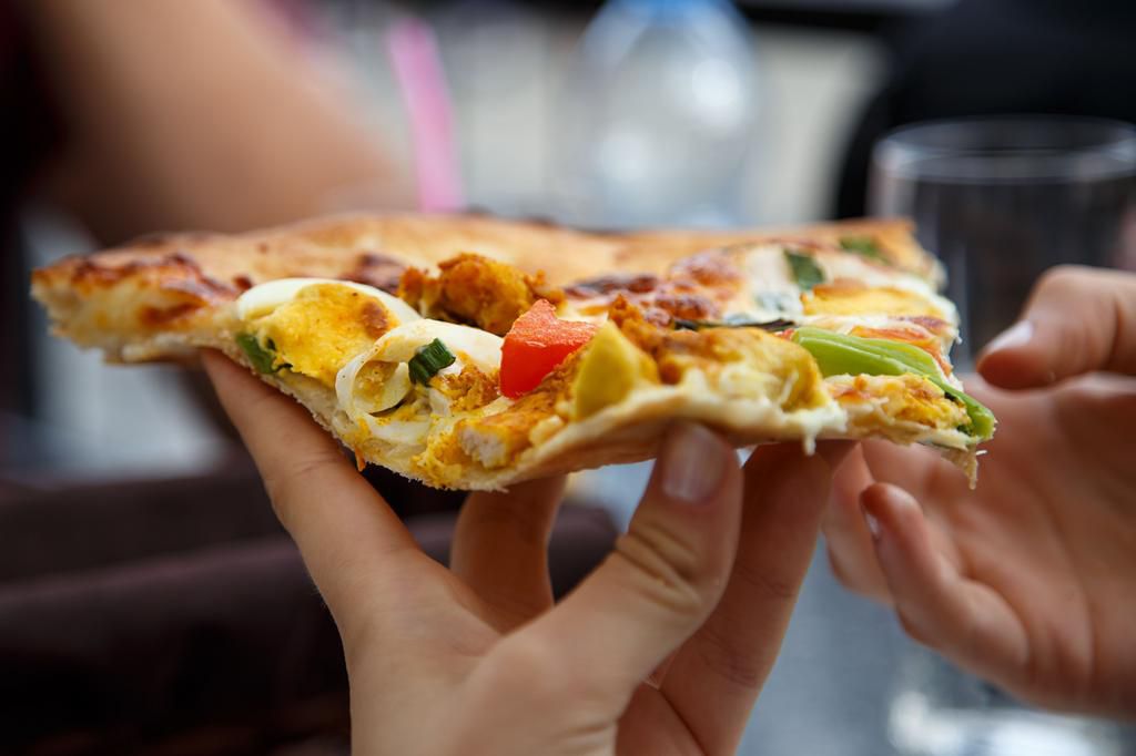 Cropped Hands Eating Pizza
