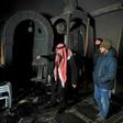 Palestinians inspect the damage from an apparent arson attack on a mosque in Israeli-occupied east Jerusalem