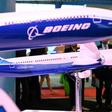 Visitors look at Boeing 787 and 777 models on display at the Singapore Airshow