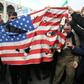 Iranians burn a US flag during a demonstration against American "crimes"