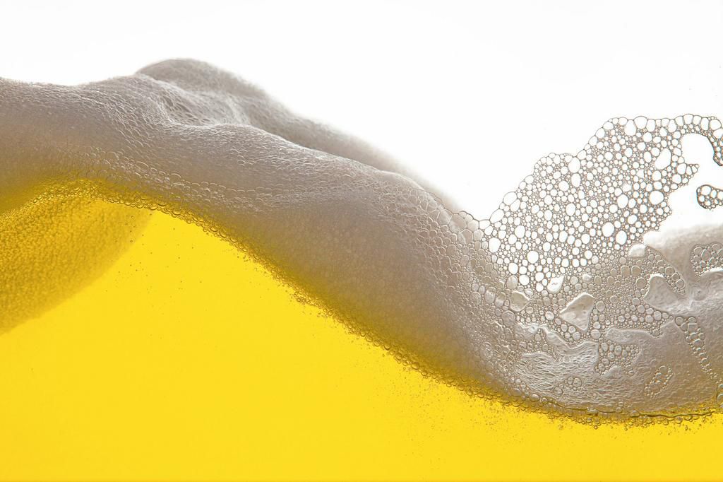 Close-Up Of Beer Against White Background