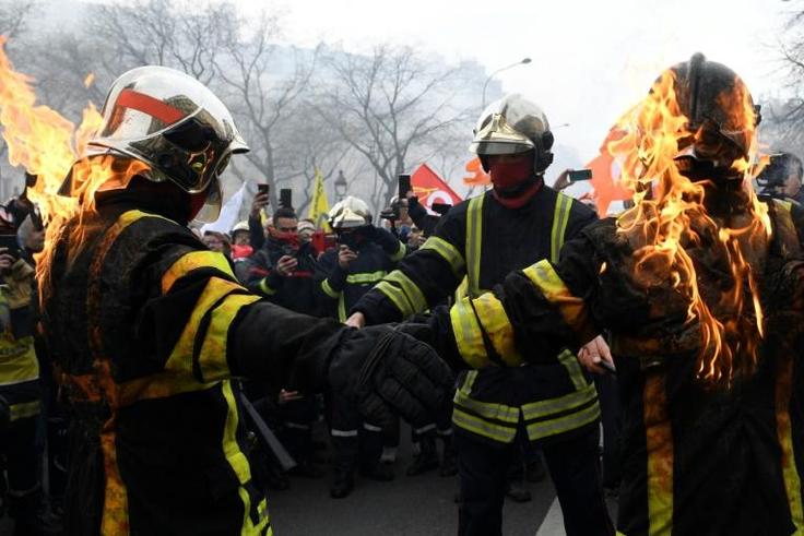 Some firefighters wearing special protective vests set fire to themselves