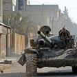 A rebel tank patrols the streets of Saraqeb, reduced to a ghost town abandoned by its residents after weeks of fighting
