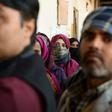 Voters queue to cast their ballots in Delhi's local elections on Saturday