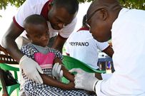 A health worker takes blood from a child in the Ivorian village of Paanenefla - The sample will be tested for sleeping sickness