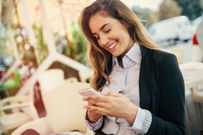 Happy businesswoman using phone